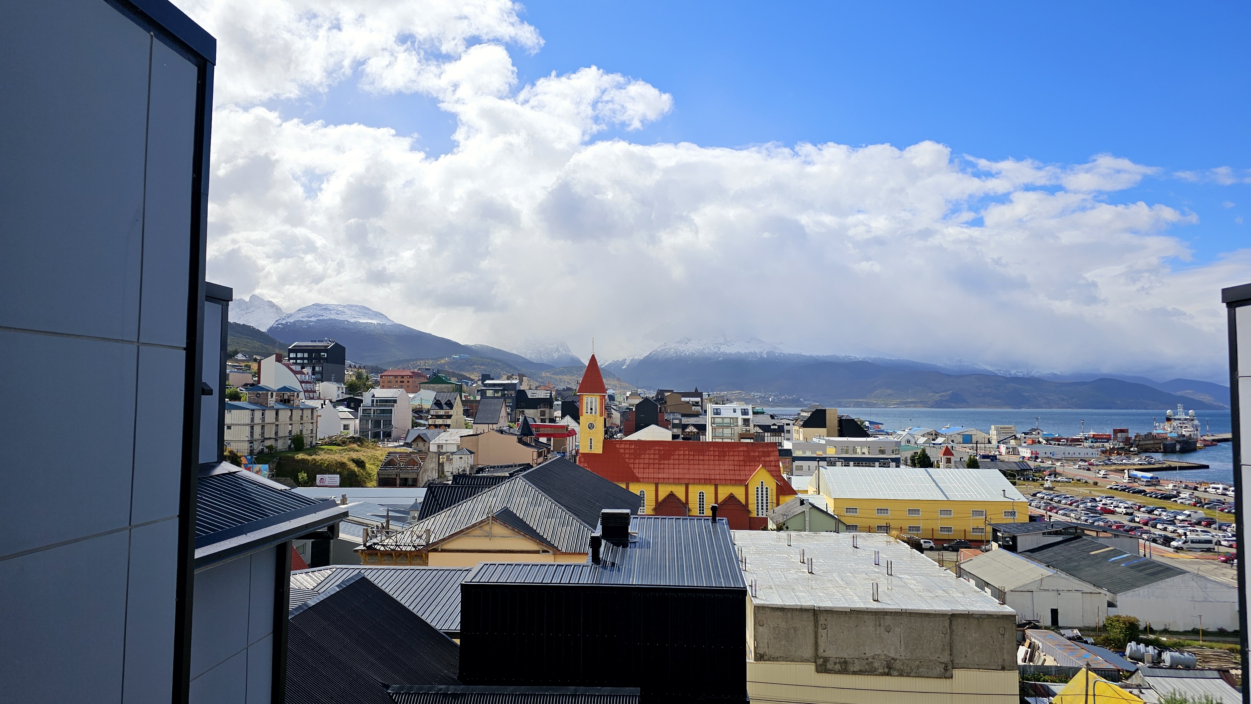 Rooftops and red church in Ushuaia under a dramatic sky