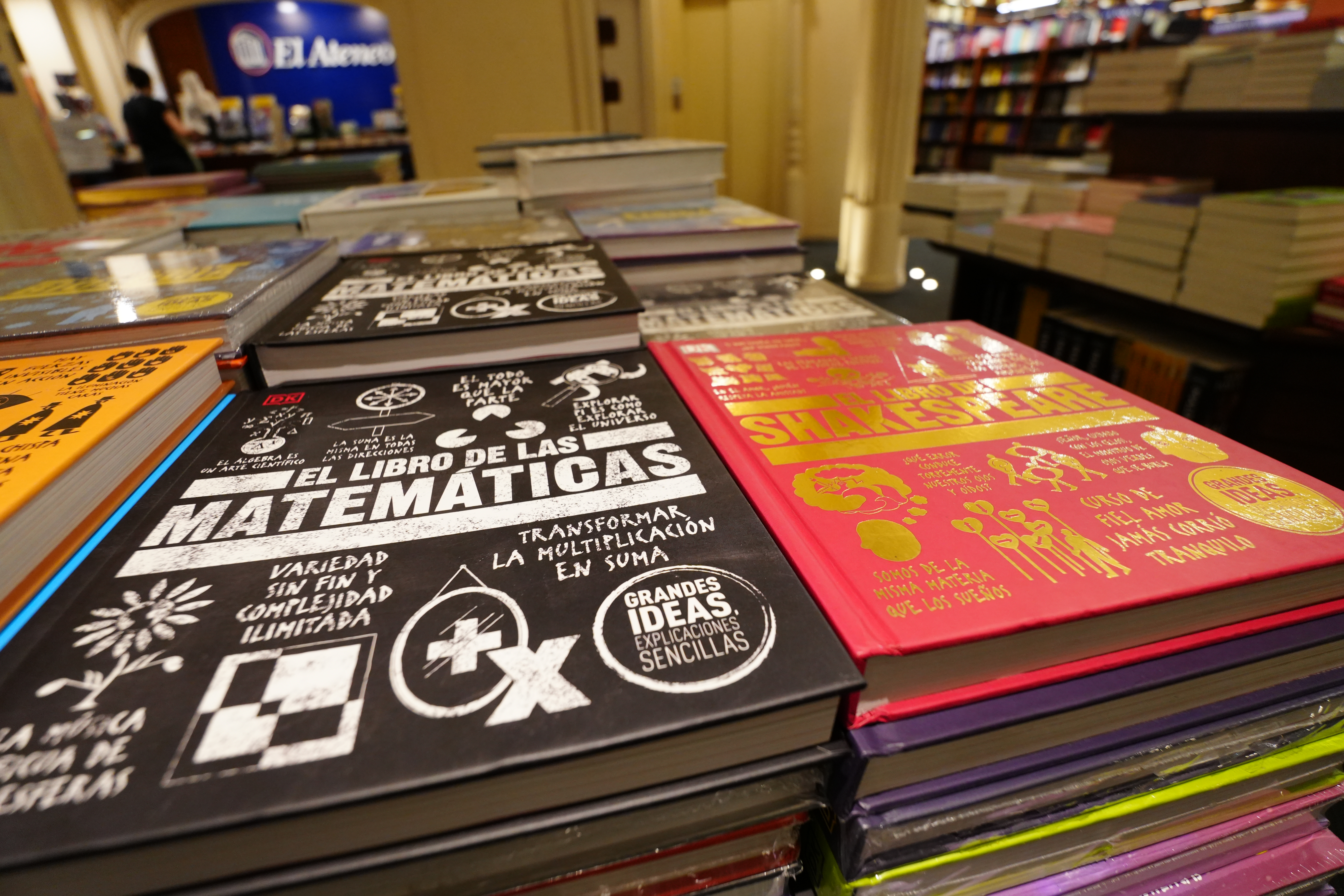 Stack of colorful books in El Ateneo bookstore.