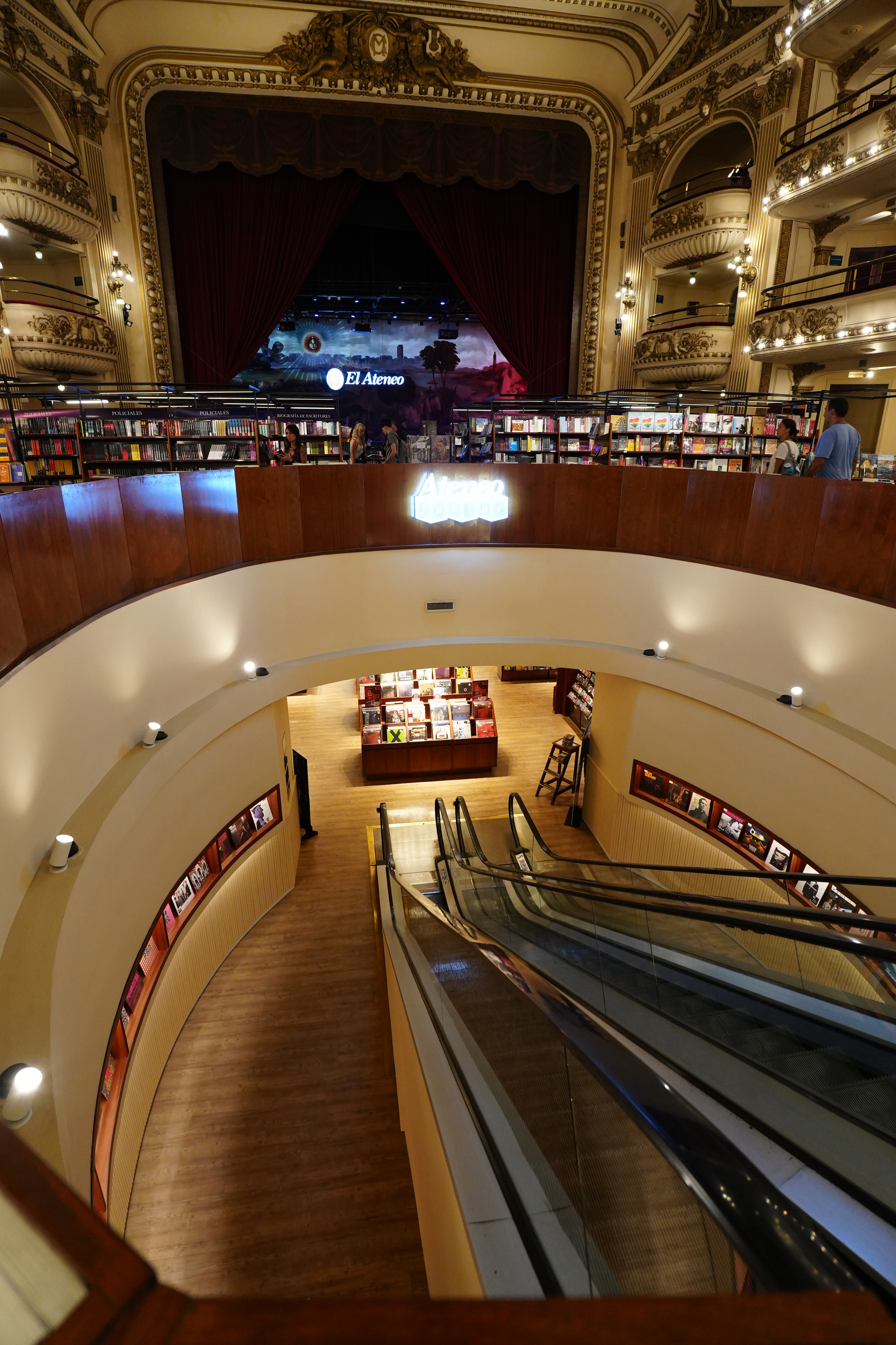 Downward view from mezzanine showing escalator and book displays below.
