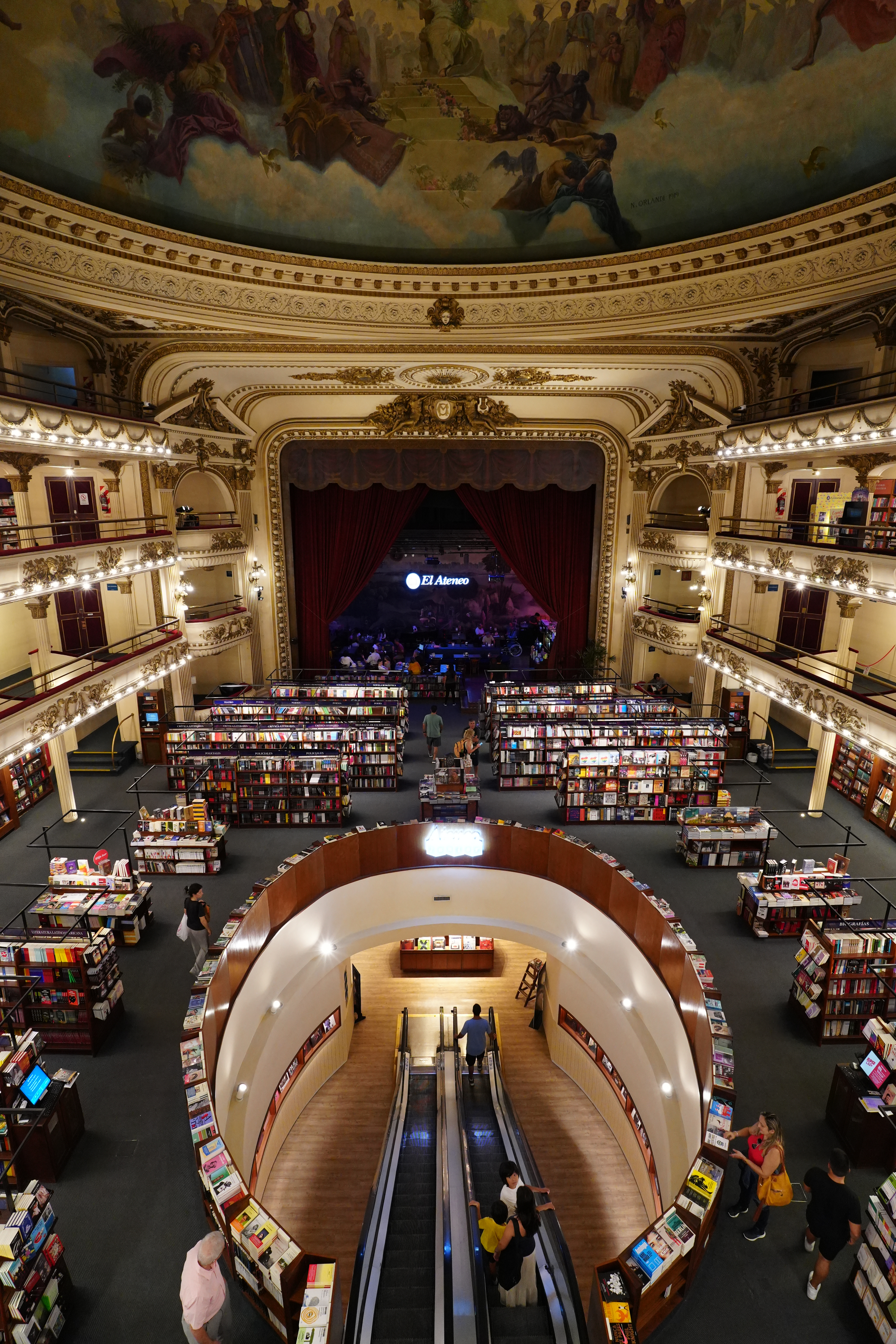 Wide shot from back of store with theater stage in view.