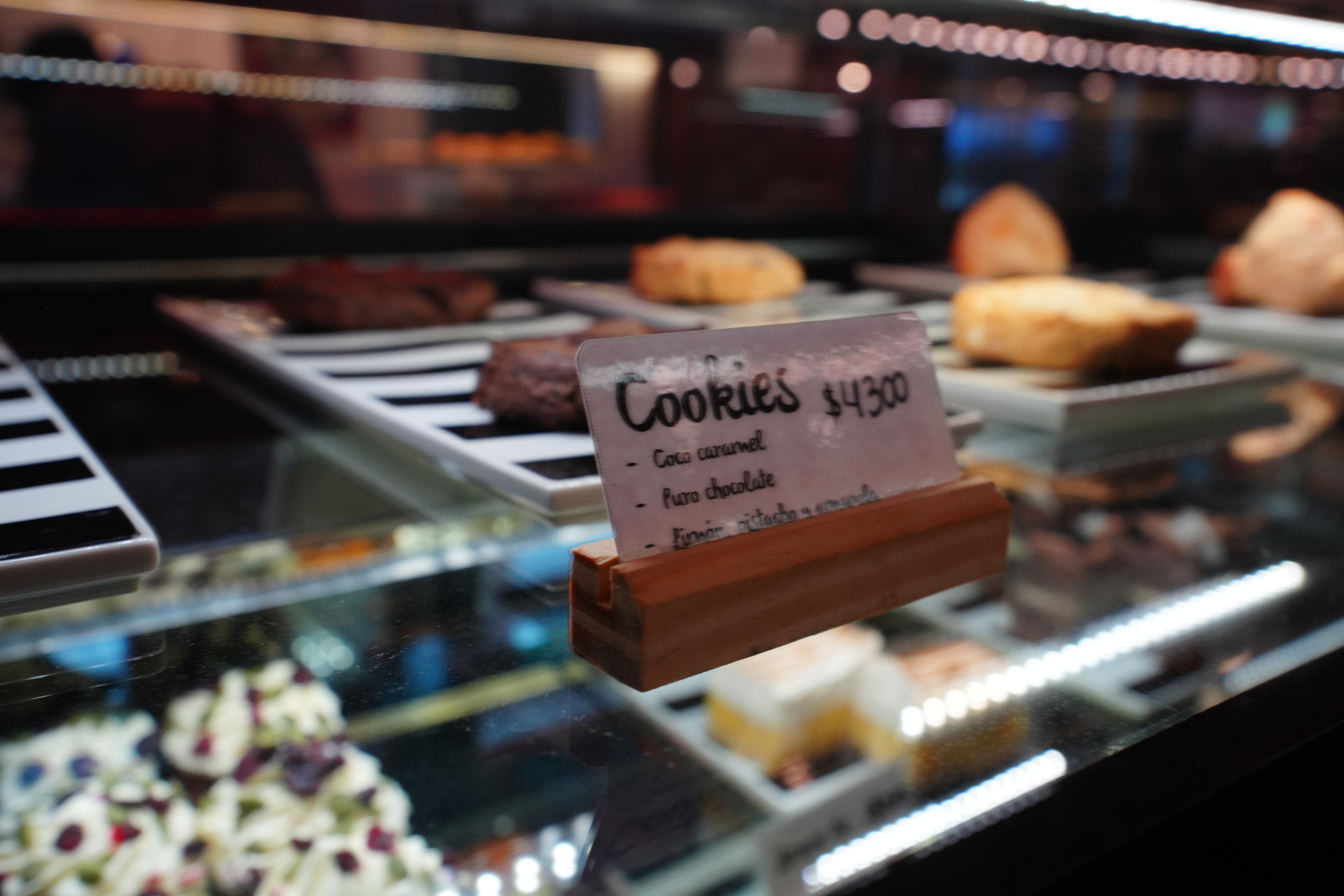 Close-up of cookie display in a glass case with small sign.