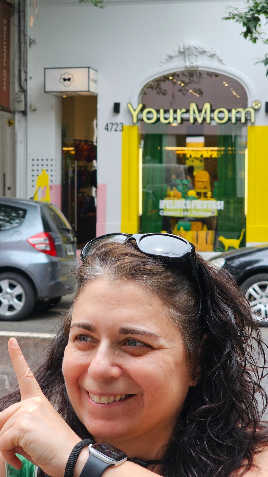 Your Mom in front of yellow storefront