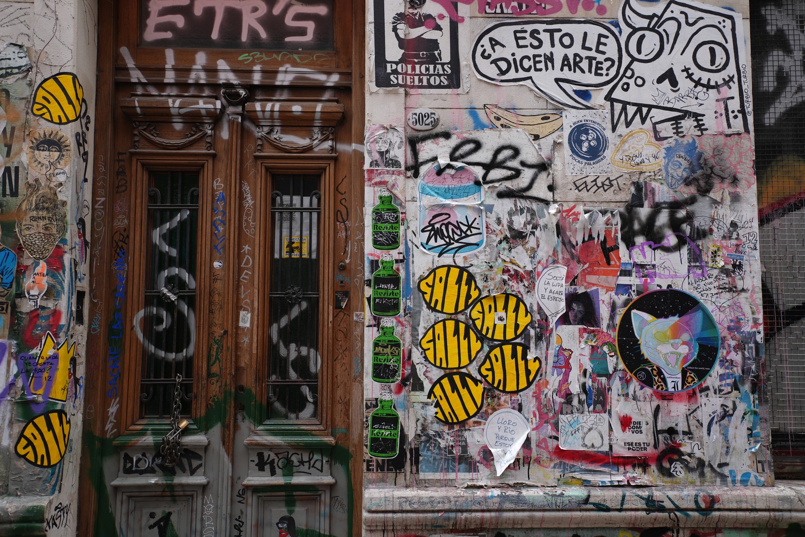 Old building covered in graffiti and posters