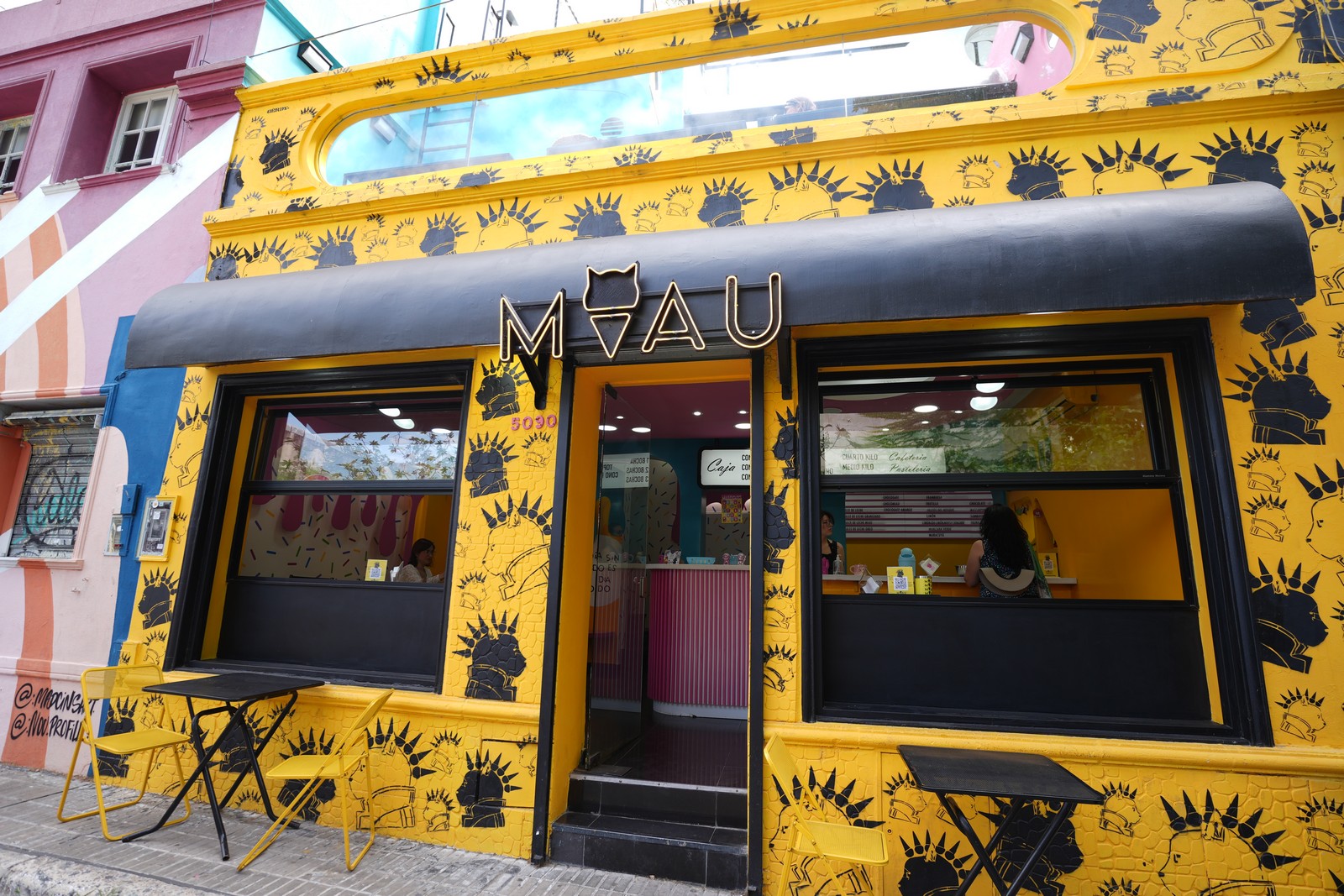 Exterior of MIAU ice cream shop with yellow cat-themed design