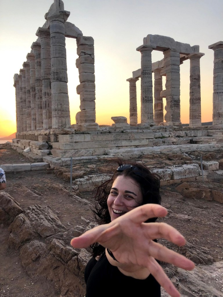 Playful photo moment at the Temple of Poseidon during golden hour