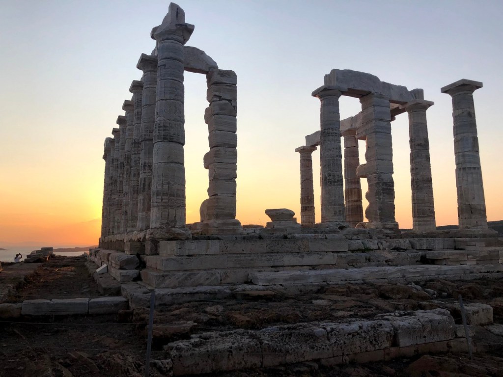 Temple of Poseidon glowing gold in the afterglow just after sunset