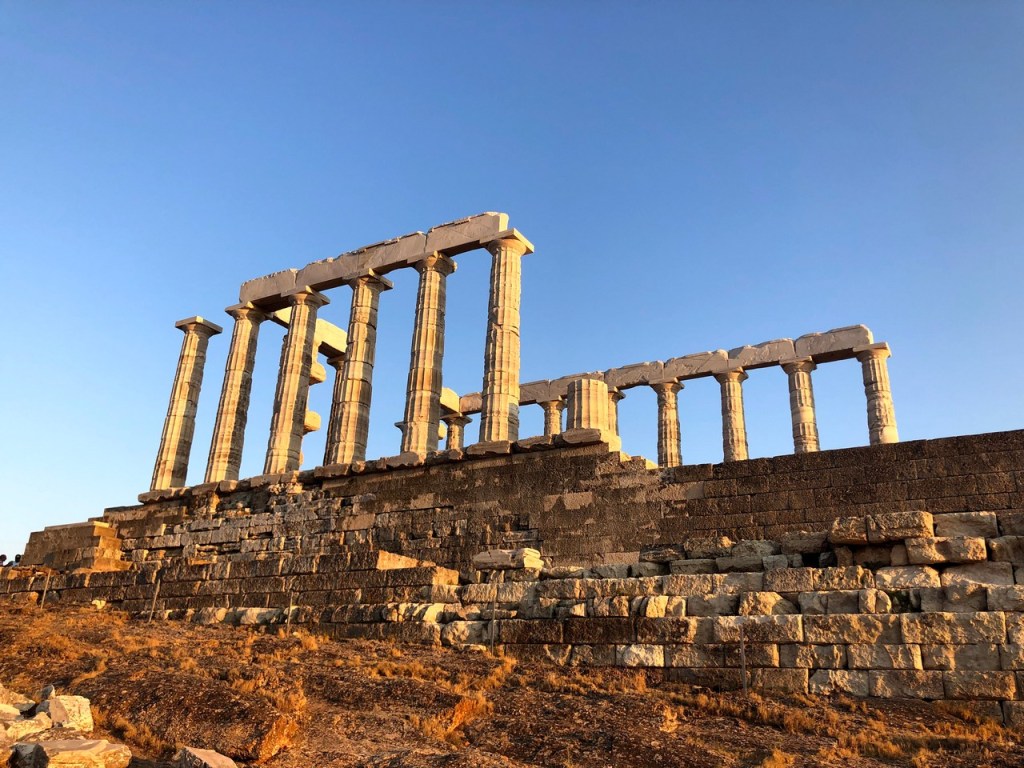 Temple of Poseidon at Cape Sounion under clear afternoon sky