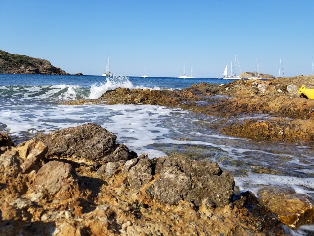 Waves breaking over rocks along the coastline near Cape Sounion